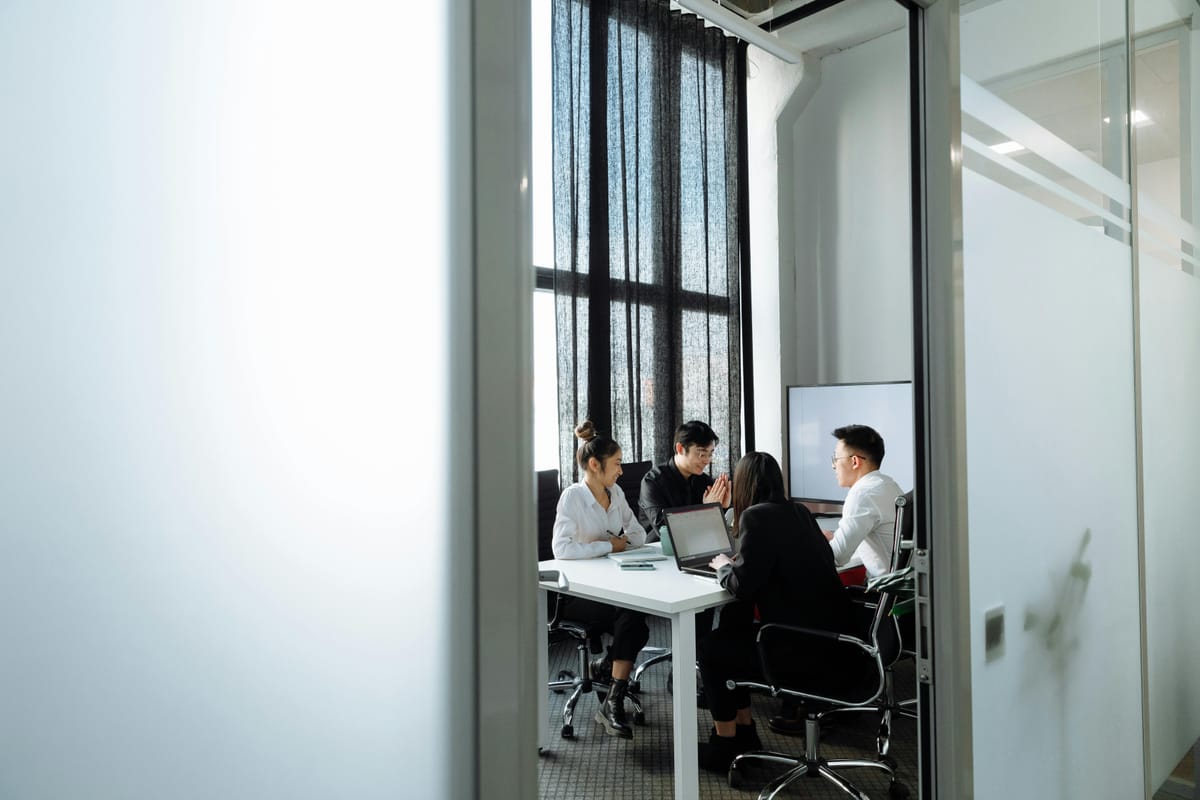 A group of people having a meeting in the office.