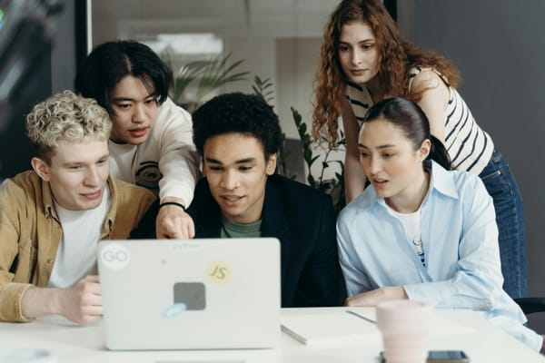 People looking at a laptop.