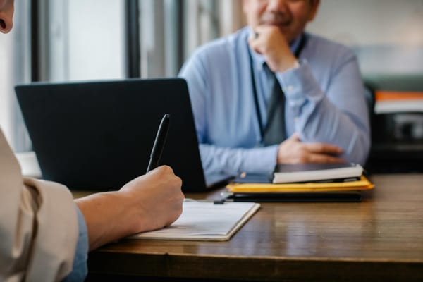 Man taking notes in the office. 