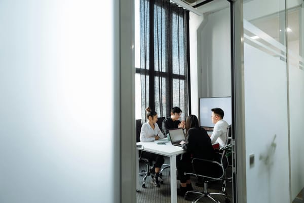 A group of people having a meeting in the office.